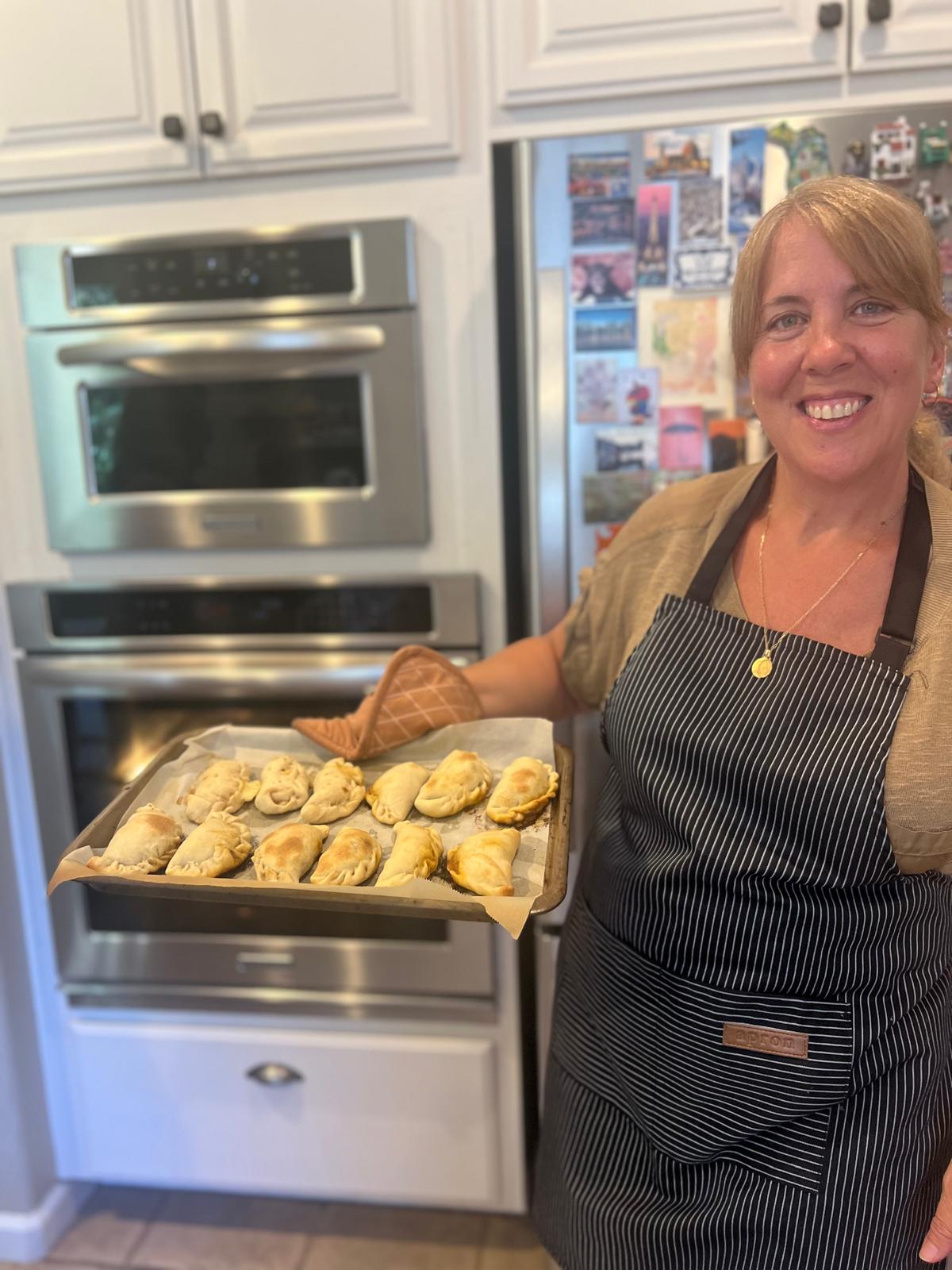 Veronique presenting fresh empanadas from the oven